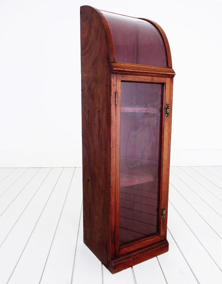 Antique mahogany storage cabinet with a curved glass top.