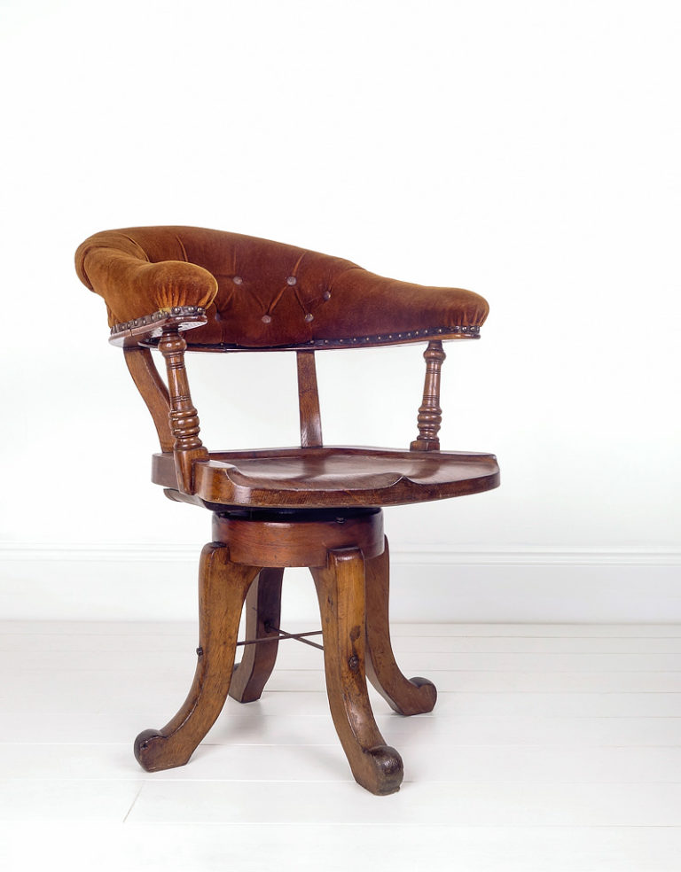 Oak revolving office chair English circa 1900. Button back support in a brown velvet material.