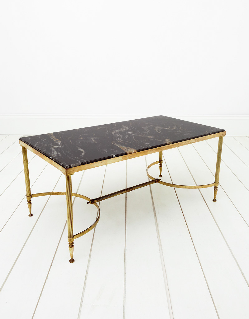 French vintage coffee table with a brass frame and a dark marble top.