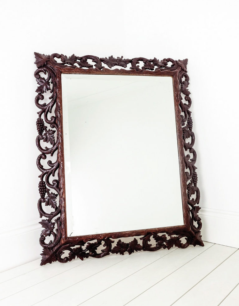 Large antique black forest mirror circa 1900, with hand carved grapes and vine leaves.