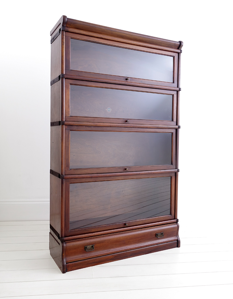 A mahogany Globe Wernicke bookcase with four glazed sections of which the bottom two are taller in height, with a single draw.