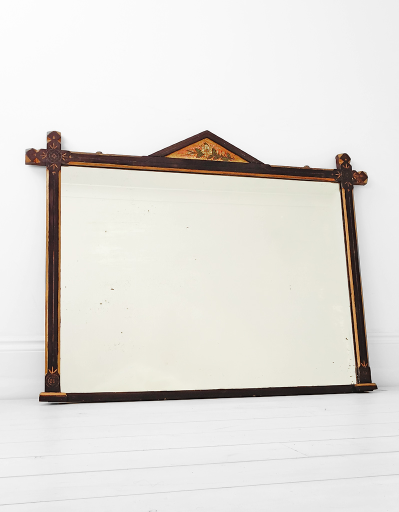 Aesthetic ebonised and gilt overmantle mirror.