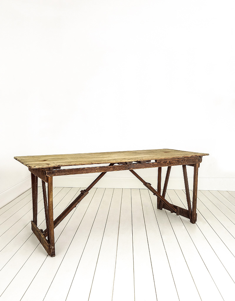 Pine rustic trestle table that can be folded and stored.