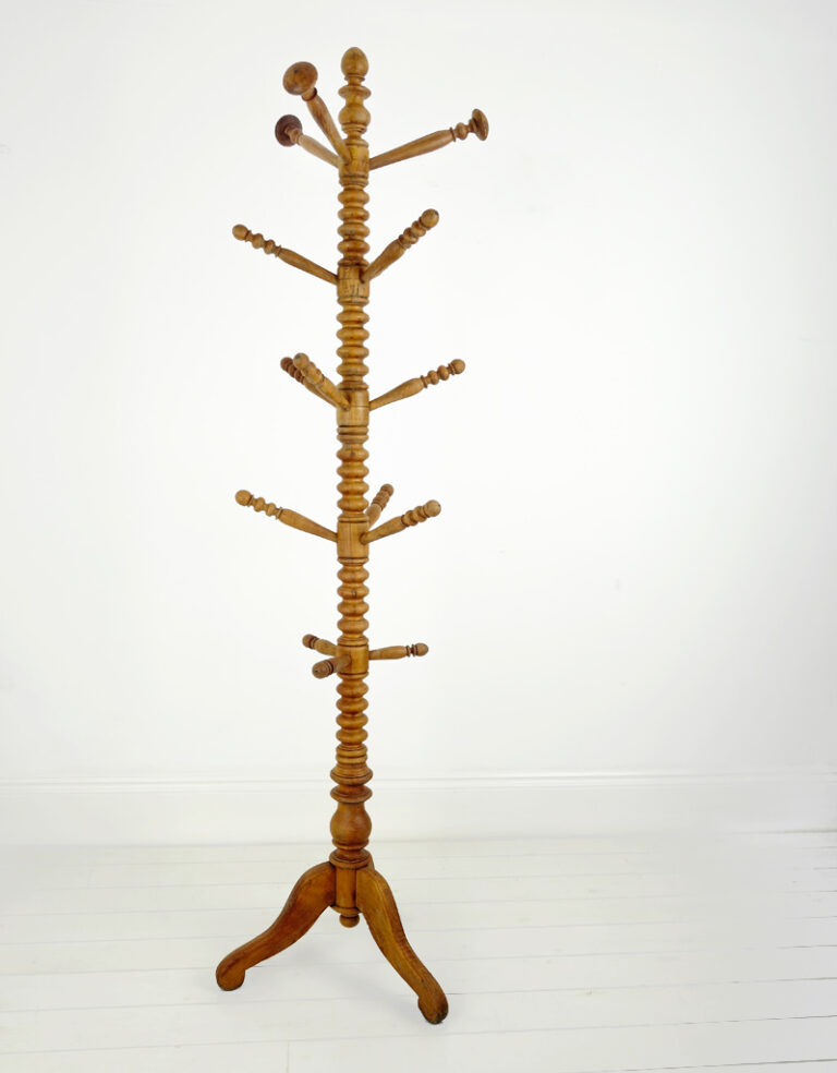 A bobbin turned birch coat stand with three scroll legs.